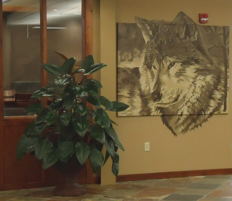 Potted Plant Next to a Wolf Painting